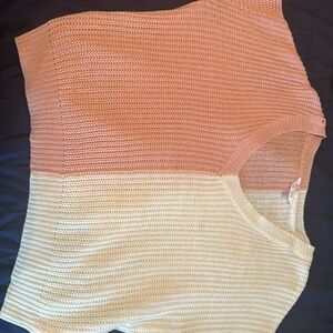 A pink and white split color sweater